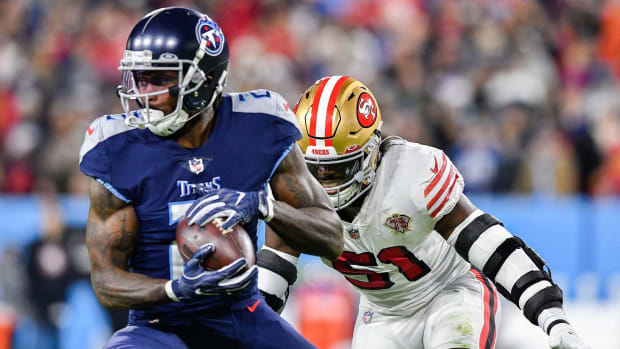 Tennessee Titans wide receiver Julio Jones (2) pulls in a catch past San Francisco 49ers linebacker Azeez Al-Shaair (51) during the first quarter at Nissan Stadium Thursday, Dec. 23, 2021 in Nashville, Tenn.